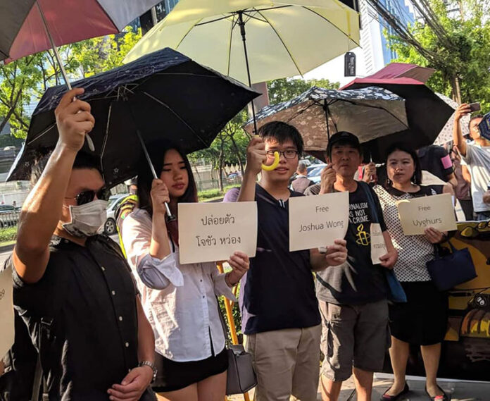 Netiwit Chotiphatphaisal, center, protests in front of the Chinese Embassy in Bangkok on June 4, 2019. Netiwit Chotiphatphaisal, center, protests in front of the Chinese Embassy in Bangkok on June 4, 2019.