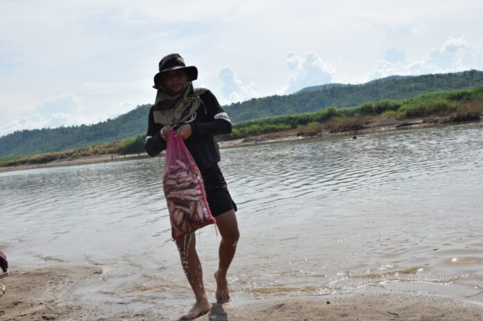A man fishes in Mekong River in Loei province on July 18, 2019.