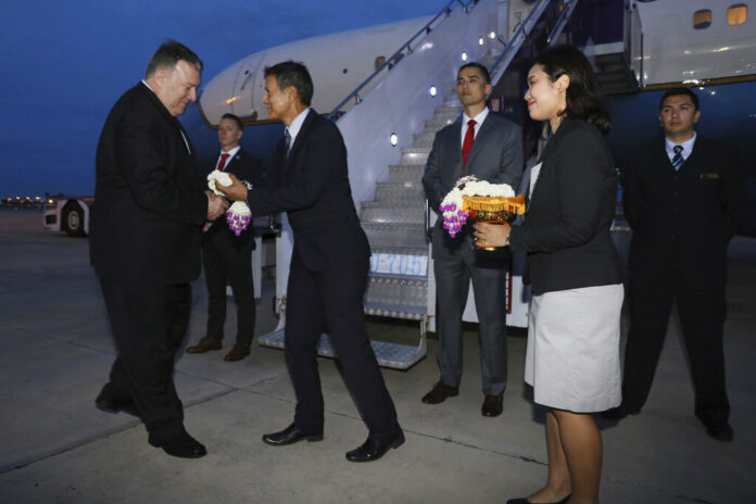 U.S. Secretary of State Mike Pompeo is presented with flowers as he boards his plane to depart for Australia from Don Mueang International Airport, in Bangkok, Thailand, Saturday, Aug. 3, 2019. Photo: Jonathan Ernst / Pool Photo via AP