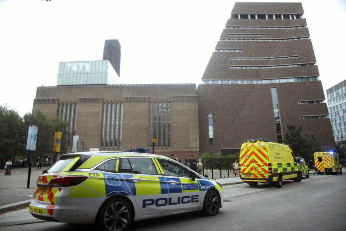 Emergency crews attending a scene at the Tate Modern art gallery, London, Sunday, Aug. 4, 2019. London police say a teenager was arrested after a child 