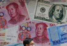 US Treasury Department Labels China a Currency Manipulator FILE - In this June 10, 2019, file photo, a man walks past a money exchange shop decorated with different banknotes at Central, a business district of Hong Kong. The U.S. Treasury Department labeled China a currency manipulator Monday, Aug. 5, after Beijing pushed down the value of its yuan in a dramatic escalation of the trade conflict between the world's two biggest economies. Photo: Kin Cheung / AP File