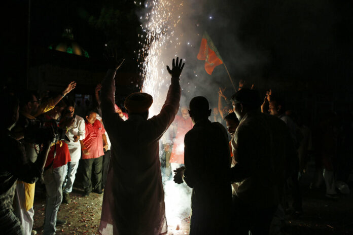 Supporters of India's ruling Bharatiya Janata Party (BJP) light firecrackers and celebrate the government revoking Kashmir's special status, in Lucknow, India, Tuesday, Aug. 6, 2019. Photo: Rajesh Kumar Singh / AP