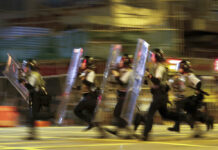 Hong Kong Reassures Visitors of Safety as Protests Continue Policemen in riot gears move to disperse the residents and protesters at Sham Shui Po district in Hong Kong, Wednesday, Aug. 7, 2019. Protesters surrounded a Hong Kong police station to demand the release of a university student arrested for apparently buying laser pointers, sparking the latest confrontation in the Chinese city. Photo: Vincent Thian / AP