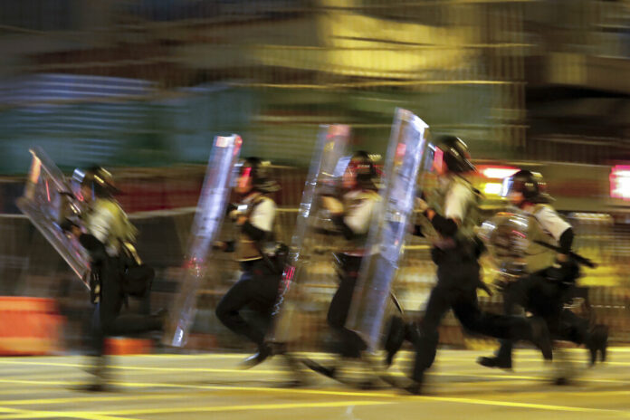 Policemen in riot gears move to disperse the residents and protesters at Sham Shui Po district in Hong Kong, Wednesday, Aug. 7, 2019. Protesters surrounded a Hong Kong police station to demand the release of a university student arrested for apparently buying laser pointers, sparking the latest confrontation in the Chinese city. Photo: Vincent Thian / AP Policemen in riot gears move to disperse the residents and protesters at Sham Shui Po district in Hong Kong, Wednesday, Aug. 7, 2019. Protesters surrounded a Hong Kong police station to demand the release of a university student arrested for apparently buying laser pointers, sparking the latest confrontation in the Chinese city. Photo: Vincent Thian / AP