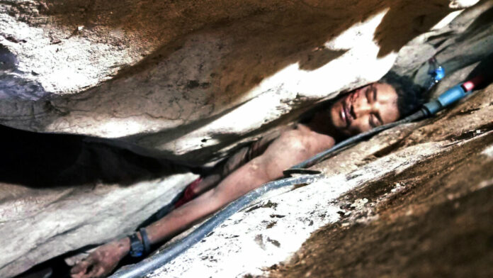 In this photo provided by Battambang province Authority Police, Sum Bora, a 28-year-old man who got stuck in the rock's hollow at Battambang province in northwestern of Phnom Penh, Cambodia, Wednesday, Aug. 7, 2019. Sum Bora, who became wedged between rocks while collecting bat droppings for sale, was rescued Wednesday after being trapped for almost four days. Photo: Battambang Province Authority Police via AP