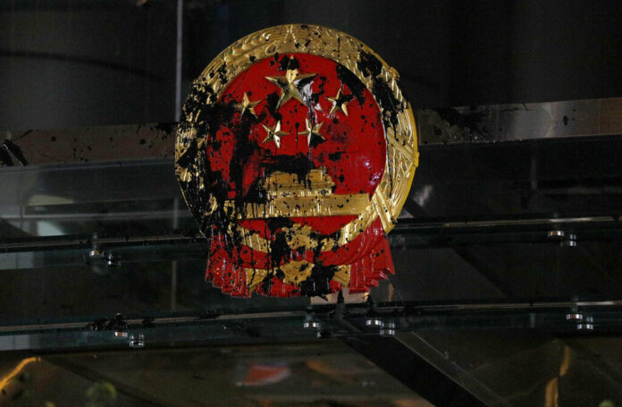 FILE - In this Sunday, July 21, 2019, file photo, the National Emblem of the People's Republic of China is covered in black paint thrown by protesters outside the Chinese Liaison Office in Hong Kong. China’s central government has dismissed Hong Kong pro-democracy protesters as clowns and criminals while bemoaning growing violence surrounding the monthslong demonstrations. Photo: Bobby Yip / AP File FILE - In this Sunday, July 21, 2019, file photo, the National Emblem of the People's Republic of China is covered in black paint thrown by protesters outside the Chinese Liaison Office in Hong Kong. China’s central government has dismissed Hong Kong pro-democracy protesters as clowns and criminals while bemoaning growing violence surrounding the monthslong demonstrations. Photo: Bobby Yip / AP File