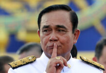 Opinion: Prayut’s Return as PM Comes With Many Unanswered Questions In this July 16, 2019, file photo, Thailand's Prime Minister Prayuth Chan-ocha gestures after a group photo with his Cabinet members at the government house in Bangkok, Thailand. Prayuth said Friday, Aug. 9, 2019 he is not quitting despite facing mounting criticism for failing to properly take his oath of office. Prayuth led members of his Cabinet to be inaugurated in a ceremony presided over by the Thai king on July 16. However, he omitted a phrase while taking the oath where he was supposed to pledge that he will uphold every aspect of the constitution. The omission has raised questions over whether the inauguration was legally valid. Photo: Sakchai Lalit / AP