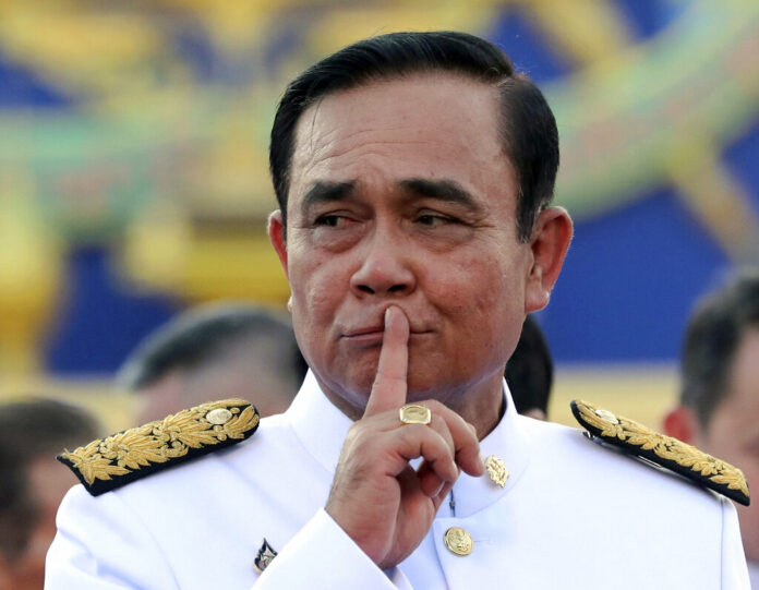 In this July 16, 2019, file photo, Thailand's Prime Minister Prayuth Chan-ocha gestures after a group photo with his Cabinet members at the government house in Bangkok, Thailand. Prayuth said Friday, Aug. 9, 2019 he is not quitting despite facing mounting criticism for failing to properly take his oath of office. Prayuth led members of his Cabinet to be inaugurated in a ceremony presided over by the Thai king on July 16. However, he omitted a phrase while taking the oath where he was supposed to pledge that he will uphold every aspect of the constitution. The omission has raised questions over whether the inauguration was legally valid. Photo: Sakchai Lalit / AP