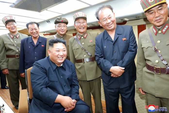 FILE - In this Saturday, Aug. 10, 2019, photo provided by the North Korean government, North Korean leader Kim Jong Un, sitting, watches test firings of short-range weapons at an undisclosed location in North Korea. North Korea on Saturday extended a recent streak of weapons displays by firing what appeared to be two short-range ballistic missiles into the sea, according to South Korea's military. The content of this image is as provided and cannot be independently verified. Korean language watermark on image as provided by source reads: 