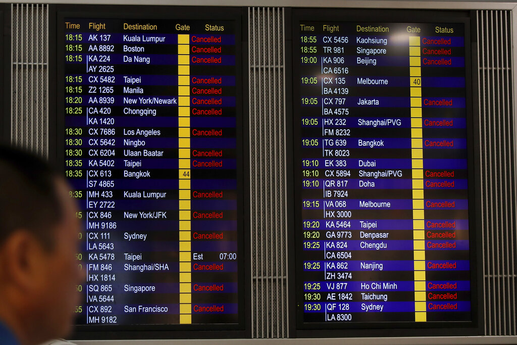 A man looks at the flight information board shows outbound flights was cancel at the Hong Kong International airport, Monday, Aug. 12, 2019. One of the world's busiest airports cancelled all remaining flights for the day after thousands of pro-democracy protesters crowded into the main terminal. Photo: Vincent Thian / AP