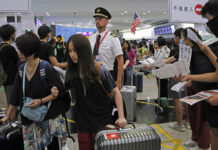 Thai Airways Flight To Hong Kong Forced to Circle Back to Bangkok Passengers and flight crew arrive at Hong Kong International Airport, Monday, Aug. 12, 2019. Photo: Kin Cheung / AP