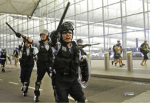 Flights Resuming at Hong Kong Airport After Protest Chaos Policemen with batons and shields shout at protesters during a demonstration at the Airport in Hong Kong, Tuesday, Aug. 13, 2019. Riot police clashed with pro-democracy protesters at Hong Kong's airport late Tuesday night, a chaotic end to a second day of demonstrations that caused mass flight cancellations at the Chinese city's busy transport hub. Photo: Vincent Yu / AP