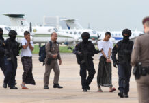 Witnesses Testify Against Bangkok Bombing Suspect Wildun Maha and Luai Sae-ngae being escorted by police on Aug. 13.