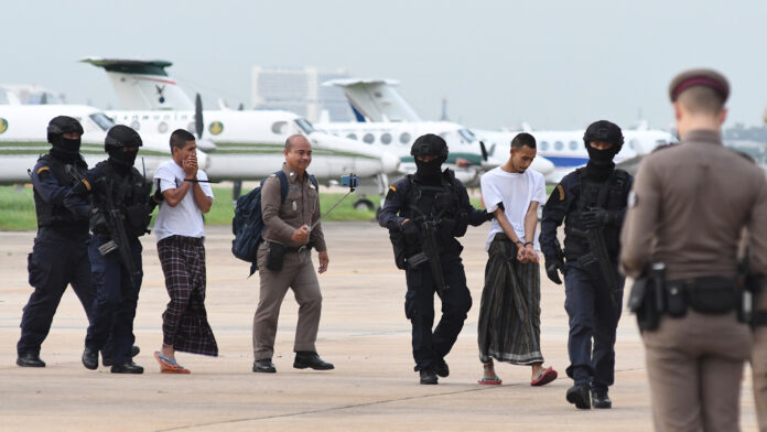 Wildun Maha and Luai Sae-ngae being escorted by police on Aug. 13. Wildun Maha and Luai Sae-ngae being escorted by police on Aug. 13.