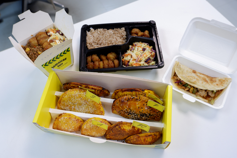 From left, clockwise: the Caribbean Box (160 baht), Super Combo Plate (320 baht) including the jerk chicken roti (120 baht), and box of pies. 