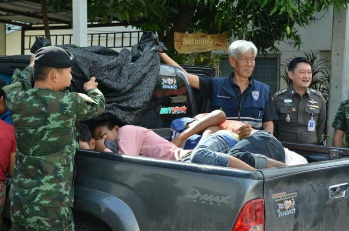 Security officers show smuggled migrant workers on the back of a pickup truck on May 26, 2017, in Kanchanaburi province.
