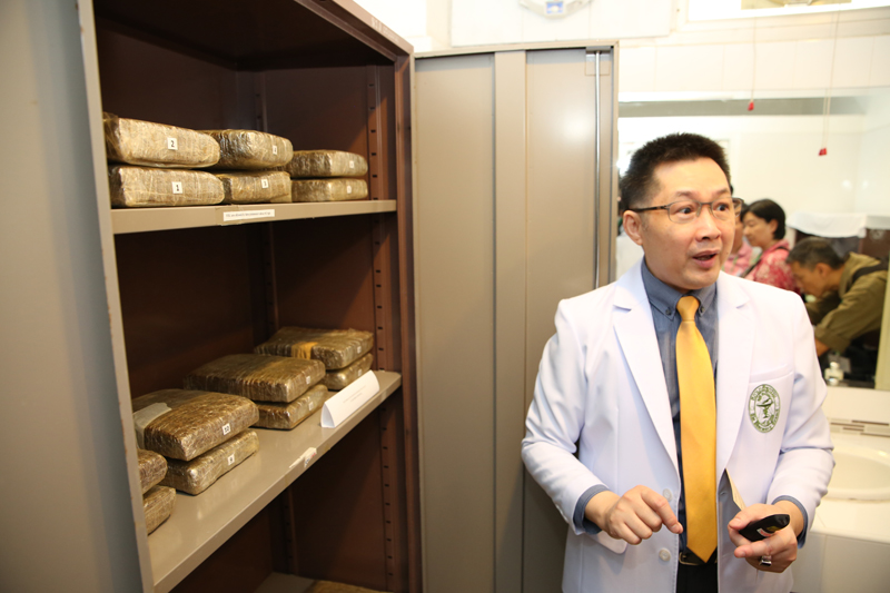 A researcher showing confiscated marijuana received from the narcotics police.