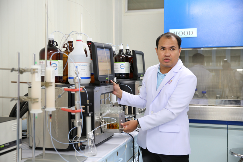 A researcher showing an extraction instrument which is used to separate different cannabis compounds.