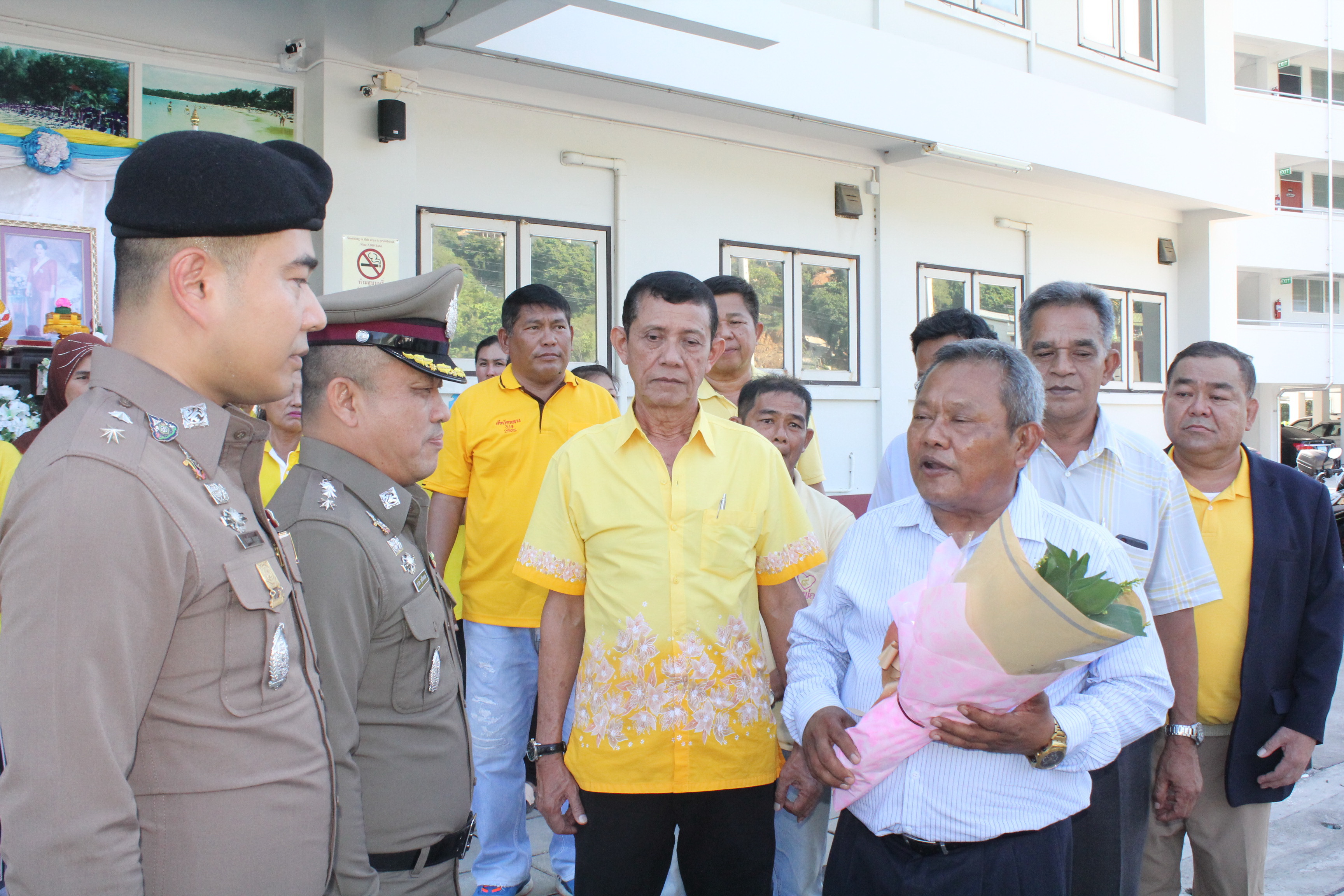 Locals giving a flower bouquet as a gesture of support to Prateung on Aug. 19.