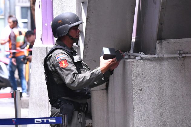 A bomb squad official inspects a black box at BTS Sala Daeng, which turned out to be a false alarm.