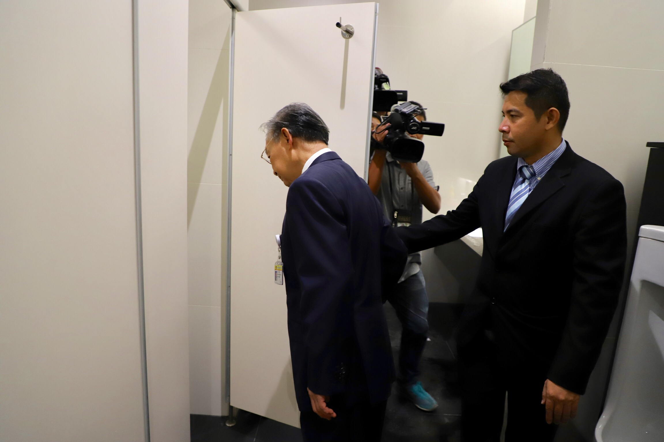Chuan looking into a toilet cubicle during a hygiene inspection of bathrooms inside the new Parliament building on Aug. 15.