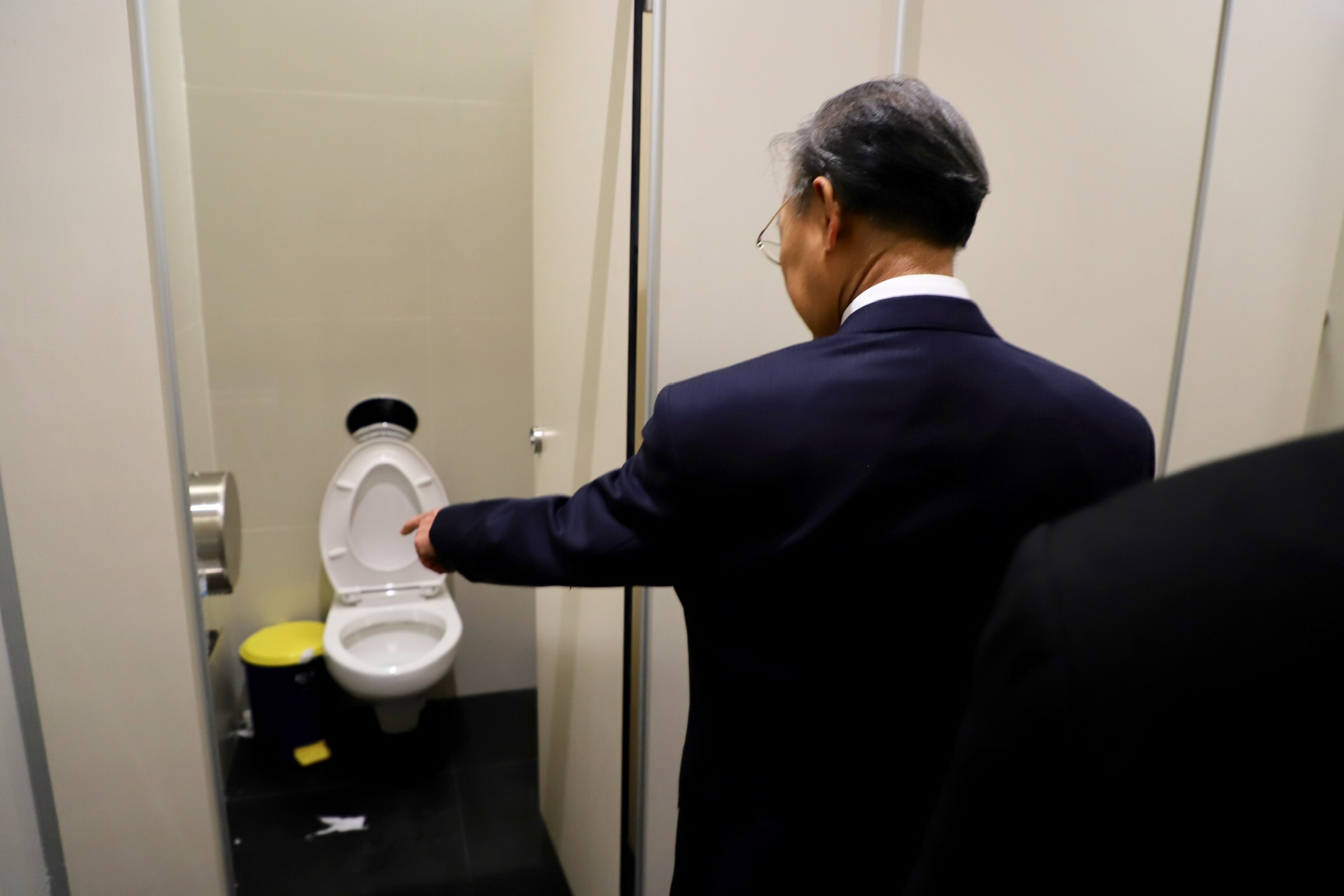 Chuan pointing at a toilet during a hygiene inspection of bathrooms inside the new Parliament building on Aug. 15.