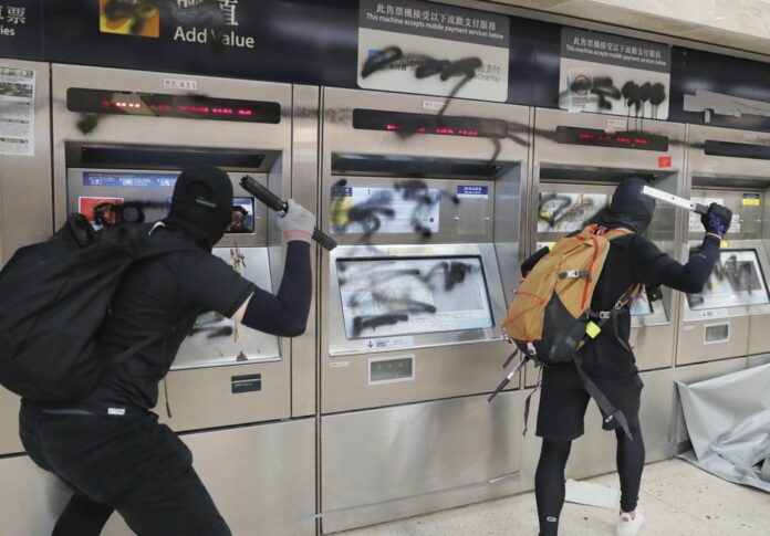 Protesters vandalize a subway station Sunday, Sept. 22, 2019, in Hong Kong. (AP Photo/Kin Cheung)