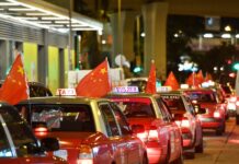 China Slams US Congressman’s Hong Kong Remark Taxis hanging China's national flags rally on the main streets of Hong Kong on Aug. 23, 2019. Photo: Liu Dawei / Xinhua