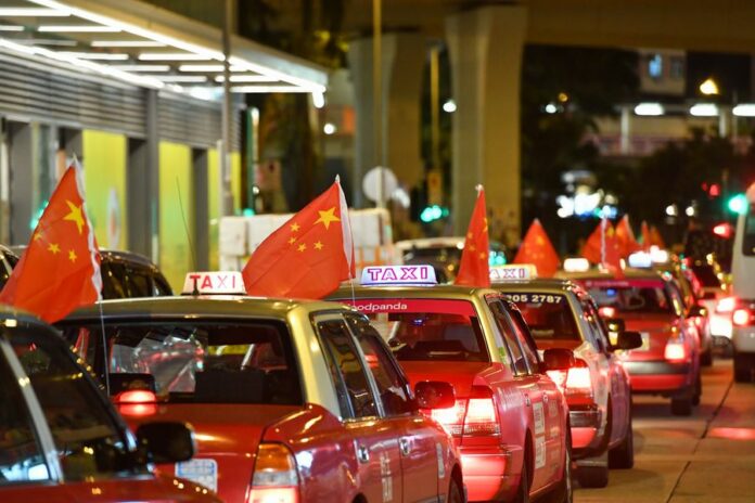 Taxis hanging China's national flags rally on the main streets of Hong Kong on Aug. 23, 2019. Photo: Liu Dawei / Xinhua Taxis hanging China's national flags rally on the main streets of Hong Kong on Aug. 23, 2019. Photo: Liu Dawei / Xinhua