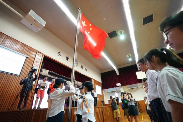 Young flag guards perform their duty at a flag-raising ceremony at the Wong Cho Bau School in China's HKSAR on Sept. 2, 2019. Photo: Qin Qing / Xinhua