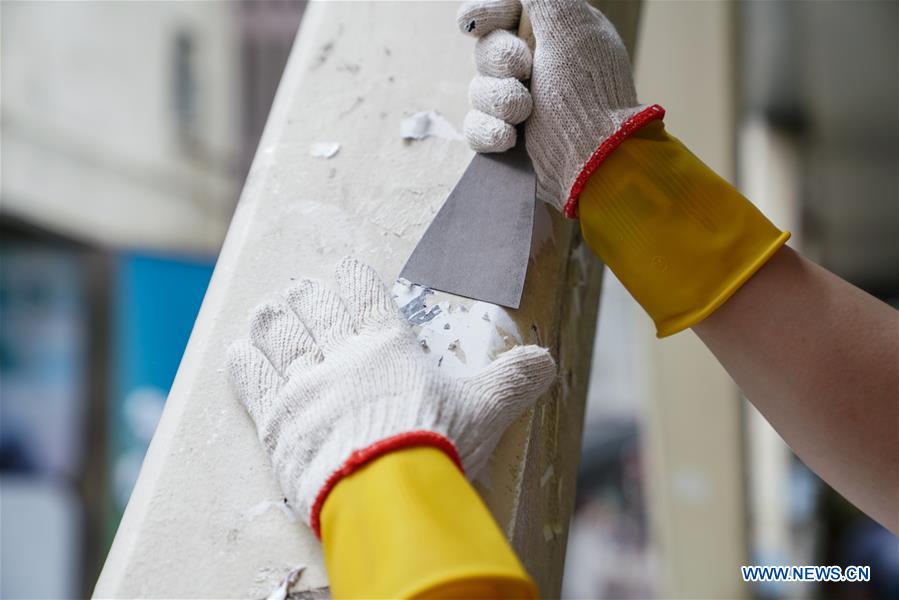 A volunteer cleans a pedestrian bridge near Wan Chai metro station in south China's Hong kong, Sept. 1, 2019. Recently, Hong Kong had some chaotic nights when rioters threw petrol bombs, set fire on roads, hurled bricks and vandalized shops and metro stations. When residents go out the next morning, they will find few traces of the tumultuous nights on the streets. A group of volunteers known as the scar removers are among the many people who have contributed to the rapid tidying-up of the ravaged streets. Photo: Mao Siqian / Xinhua