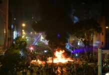 Protests in Hong Kong Hit Economy Hard, US Academic Says Protesters shine laser beams and set fires near the Hong Kong police headquarters in Wan Chai in the HKSAR, Aug. 31, 2019. Photo: Xinhua
