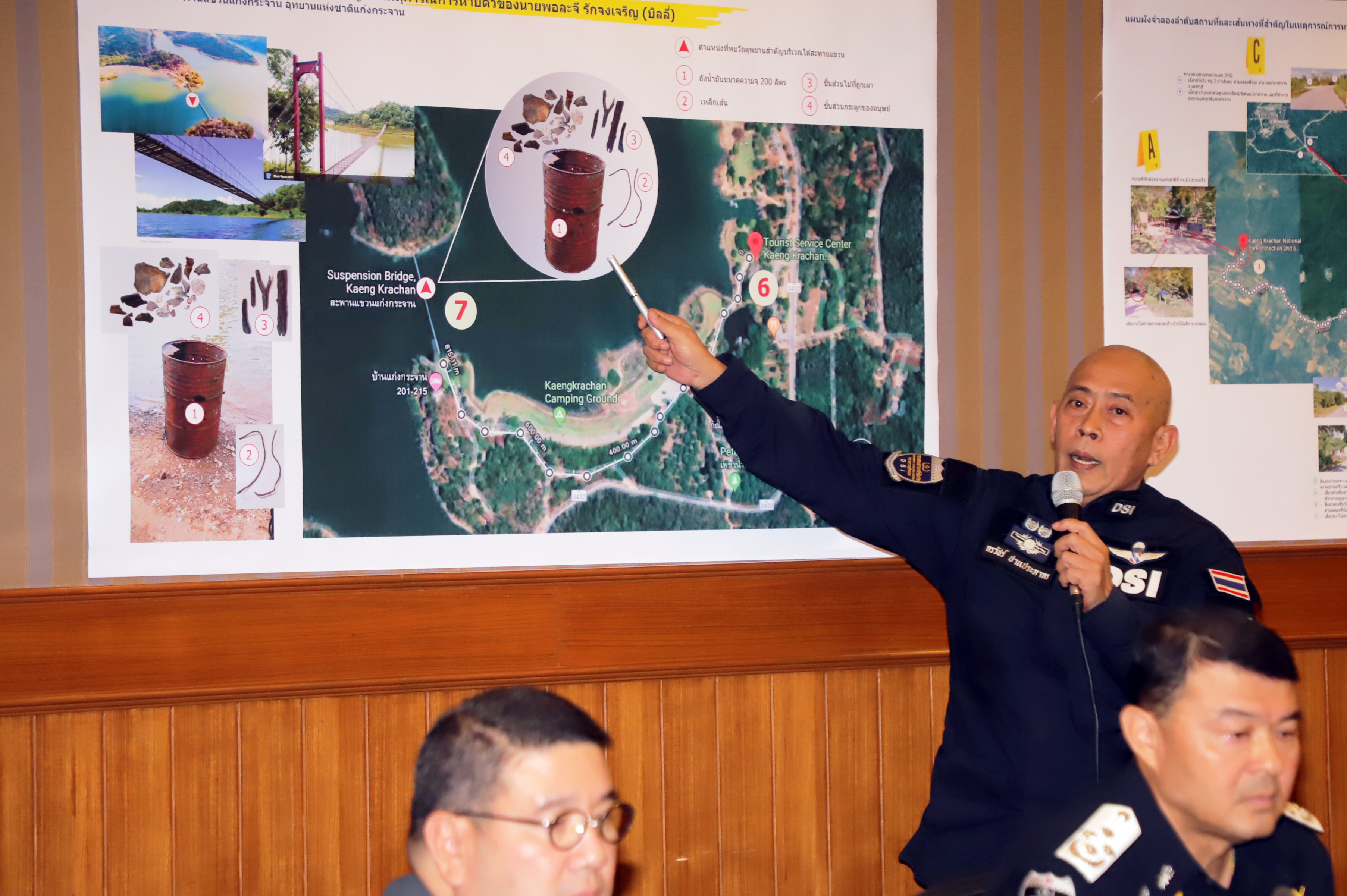 A DSI official pointing at a poster which shows evidence such as an oil drum, two metal rods, bone fragments, and wooden sticks found at the scene during a press conference on Sept. 3.