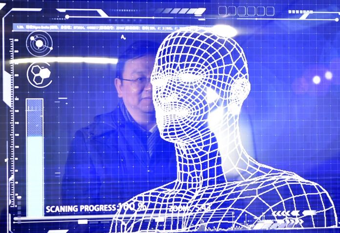 A manager of China's leading new energy vehicle maker BYD tries the facial recognition for starting a