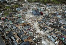 Hurricane Death Toll in Bahamas at 30 as Aid Begins to Land People walk through a neighborhood destroyed by Hurricane Dorian at Marsh Harbour in Great Abaco Island, Bahamas on Thursday, Sept. 5, 2019. Photo: Al Diaz / Miami Herald via AP