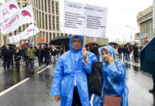 Russian Investigators Drop Charges Against 5 Protesters In this photo taken on Aug. 10, 2019, Vyacheslav Abanichev and Alisa Abanicheva, parents of Sergei Abanichev charged with rioting connected to an opposition rally, hold a poster saying "Free My Son" with the names of all those arrested as they attend an opposition rally in Moscow, Russia. Fourteen Russians have been slapped with charges of rioting stemming from an opposition protest in July in Moscow in a criminal inquiry largely seen as a Kremlin intimidation tactic. Photo: Daria Zelenaya / Novaya gazeta via AP
