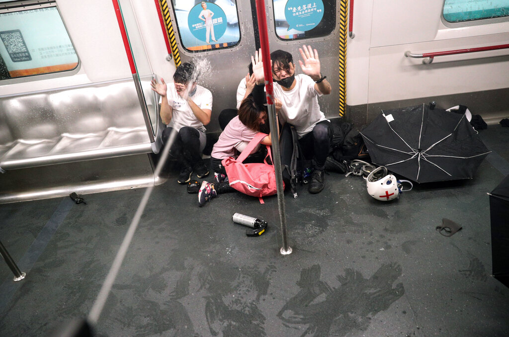 Police shoot pepper spray as they try to detain protesters inside a train at Prince Edward MTR Station, Hong Kong, Saturday, Aug. 31, 2019. Hundreds of people are rallying in an athletic park in central Hong Kong as a 13th-straight weekend of pro-democracy protests gets underway. Photo: Ring Yu / HK01 via AP