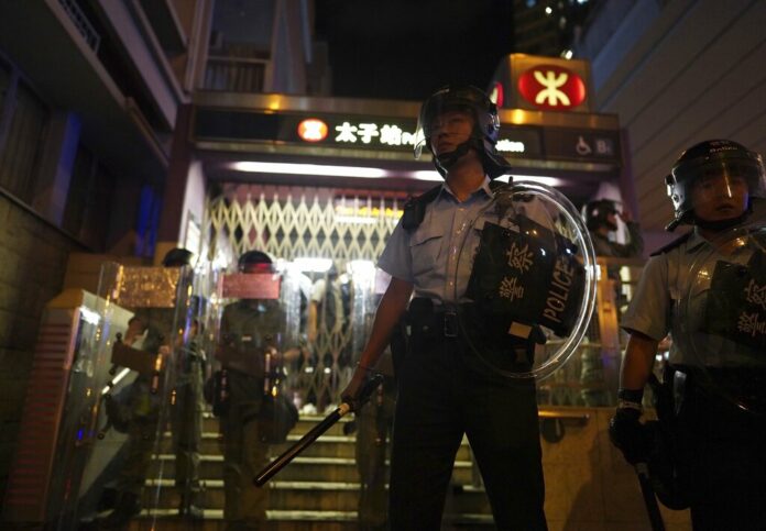 Police stand guard outside while police arrest protesters at Prince Edward MTR Station, Hong Kong, Saturday, Aug. 31, 2019. Hundreds of people are rallying in an athletic park in central Hong Kong as a 13th-straight weekend of pro-democracy protests gets underway. Photo: Vincent Yu / AP Police stand guard outside while police arrest protesters at Prince Edward MTR Station, Hong Kong, Saturday, Aug. 31, 2019. Hundreds of people are rallying in an athletic park in central Hong Kong as a 13th-straight weekend of pro-democracy protests gets underway. Photo: Vincent Yu / AP