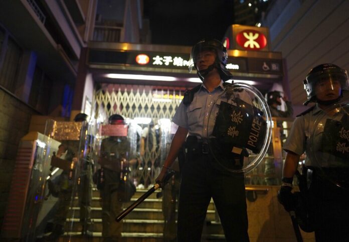 Police stand guard outside while police arrest protesters at Prince Edward MTR Station, Hong Kong, Saturday, Aug. 31, 2019. Hundreds of people are rallying in an athletic park in central Hong Kong as a 13th-straight weekend of pro-democracy protests gets underway. Photo: Vincent Yu / AP