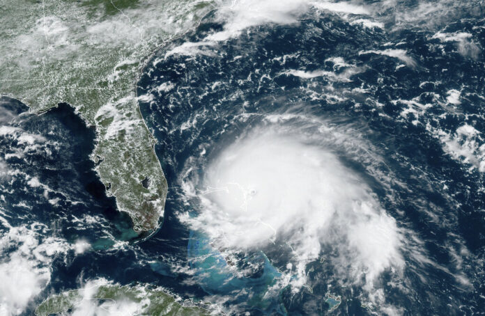 This GOES-16 satellite image taken Sunday, Sept. 1, 2019, at 17:00 UTC and provided by National Oceanic and Atmospheric Administration (NOAA), shows Hurricane Dorian, right, churning over the Atlantic Ocean. Hurricane Dorian struck the northern Bahamas on Sunday as a catastrophic Category 5 storm, its 185 mph winds ripping off roofs and tearing down power lines as hundreds hunkered in schools, churches and other shelters. Photo: NOAA via AP