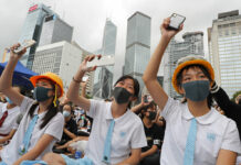 Tens of Thousands in Hong Kong Boycott First Day of School Students wear protective gear during a protest in Hong Kong, Monday, Sept. 2, 2019. Hong Kong has been the scene of tense anti-government protests for nearly three months. The demonstrations began in response to a proposed extradition law and have expanded to include other grievances and demands for democracy in the semiautonomous Chinese territory. Photo: Kin Cheung / AP