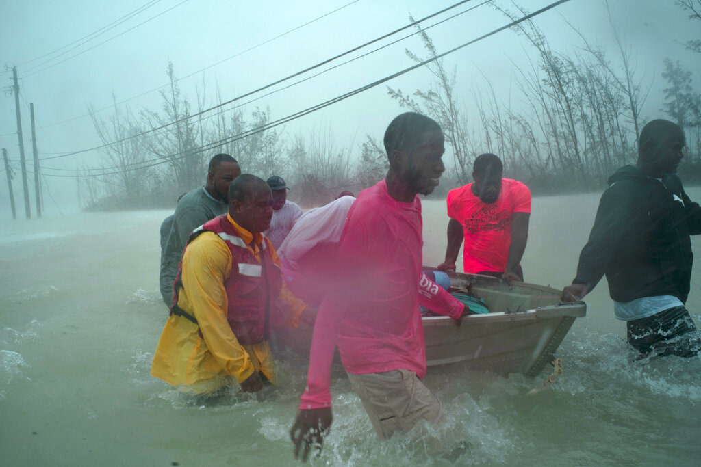 Volunteers rescue several families from the rising waters of Hurricane Dorian, near the Causarina bridge in Freeport, Grand Bahama, Bahamas, Tuesday, Sept. 3, 2019. The storm’s punishing winds and muddy brown floodwaters devastated thousands of homes, crippled hospitals and trapped people in attics. Photo: Ramon Espinosa / AP