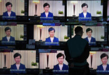 Lam Says Extradition Bill Will End Without Debate or Vote A man watches the television message that Hong Kong Chief Executive Carrie Lam makes an announcement on the extradition bill, at a home electronics retailer in Hong Kong, on Wednesday, Sept. 4, 2019. Photo: Vincent Yu / AP