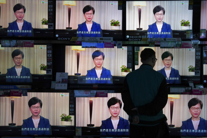 A man watches the television message that Hong Kong Chief Executive Carrie Lam makes an announcement on the extradition bill, at a home electronics retailer in Hong Kong, on Wednesday, Sept. 4, 2019. Photo: Vincent Yu / AP