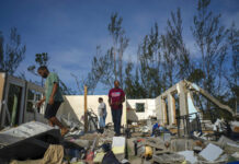 Hurricane Death Toll Climbs to 20 in Devastated Bahamas George Bolter, left, and his parents walk through the remains of his home destroyed by Hurricane Dorian in the Pine Bay neighborhood of Freeport, Bahamas, Wednesday, Sept. 4, 2019. Photo: Ramon Espinosa / AP