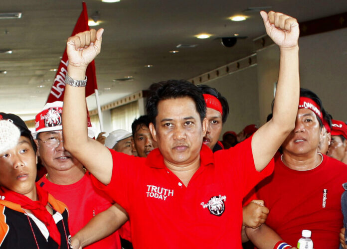 In this April 11, 2009, file photo, anti-government leader Arisman Pongruangrong is cheered as he and others march through the 14th ASEAN Convention Center in Pattaya, Thailand. Thailand's Supreme Court has affirmed the prison sentences of 12 members of the 