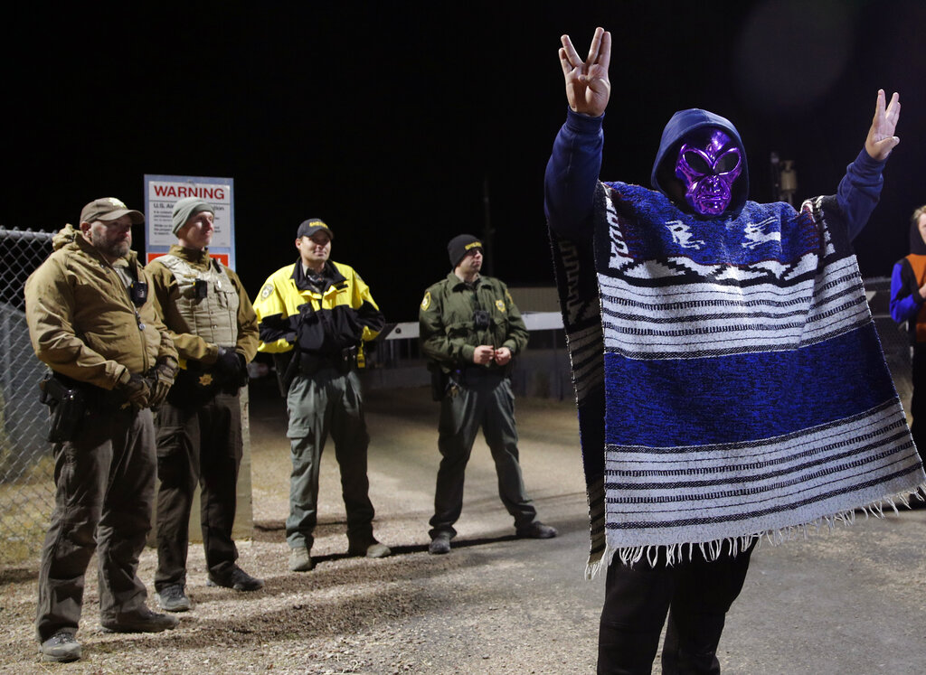 A man in an alien mask stands at an entrance to the Nevada Test and Training Range near Area 51 Friday, Sept. 20, 2019, outside of Rachel, Nev. People gathered at the gate inspired by the "Storm Area 51" internet hoax. Photo: John Locher / AP
