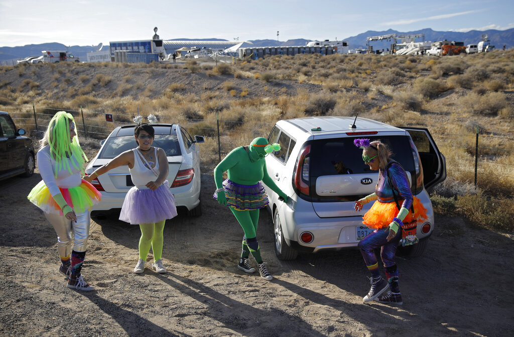 From left, Alex Clark, Carolyn Milner, Audrie Clark and Lucinda Clark dance near their car outside of the Storm Area 51 Basecamp event Friday, Sept. 20, 2019, in Hiko, Nev. The event was inspired by the "Storm Area 51" internet hoax. Photo: John Locher / AP