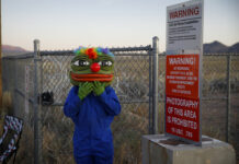 Area 51 Events Mostly Peaceful; Thousands in Nevada Desert Martin Custodio wears a Pepe mask while standing near razor wire at an entrance to the Nevada Test and Training Range near Area 51, Friday, Sept. 20, 2019, near Rachel, Nev. People came to visit the gate inspired by the "Storm Area 51" internet hoax. Photo: John Locher / AP