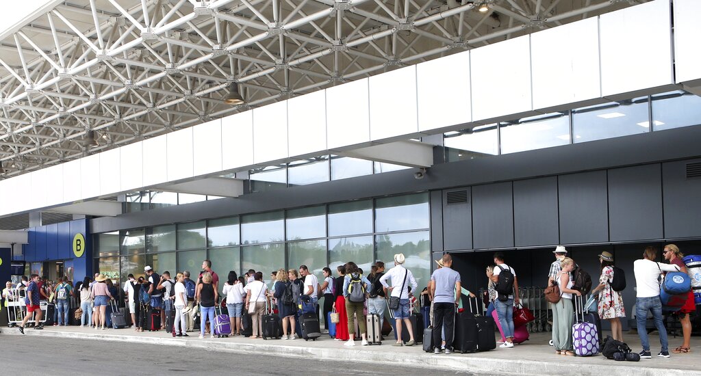 British tourists wait in a queue at the Ioannis Kapodistrias Airport in Corfu island, northwestern Greece, Monday, Sept. 23, 2019. Hundreds of thousands of travellers were stranded across the world Monday after British tour company Thomas Cook collapsed, immediately halting almost all its flights and hotel services and laying off all its employees. Photo: Stamatis Katopodis / InTime News via AP